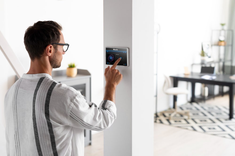 Man operating AI-powered home security control panel in smart home