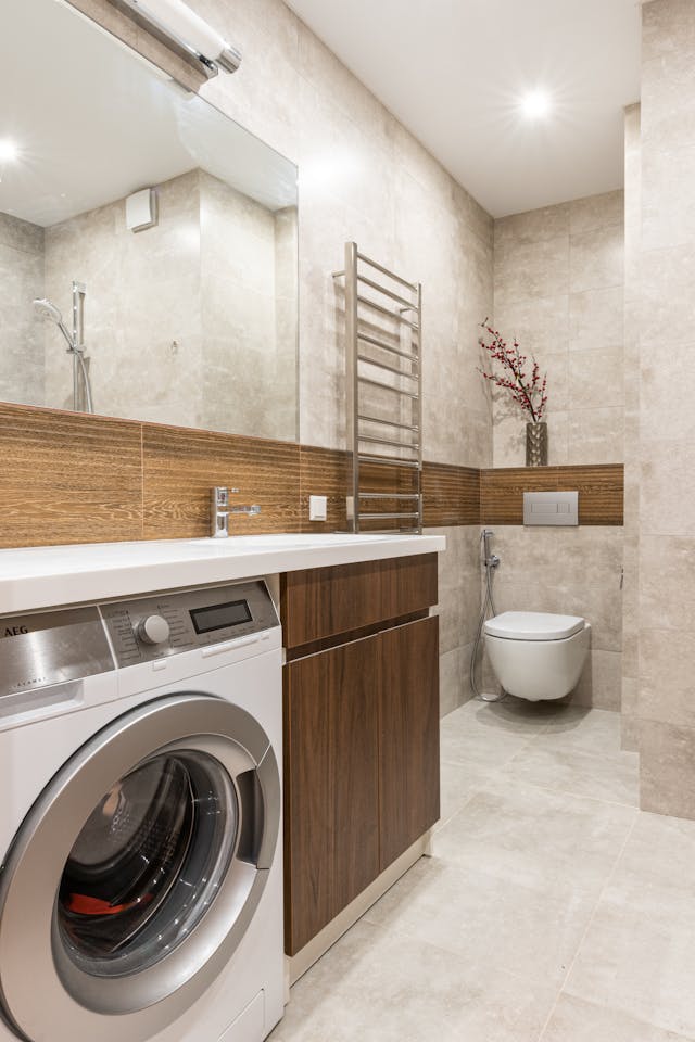 Front-load washing machine installed in a modern bathroom interior